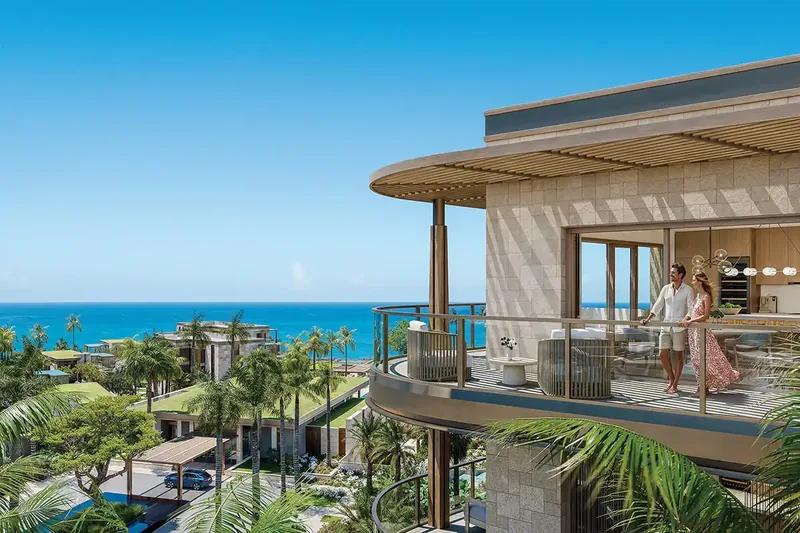 Artist’s rendering of an apartment terrace above a resort, palms and the sea beyond