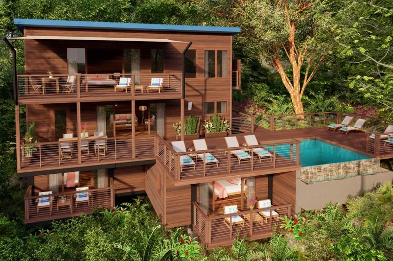 A timber villa of stacked balconies with a pool, set among rainforest trees