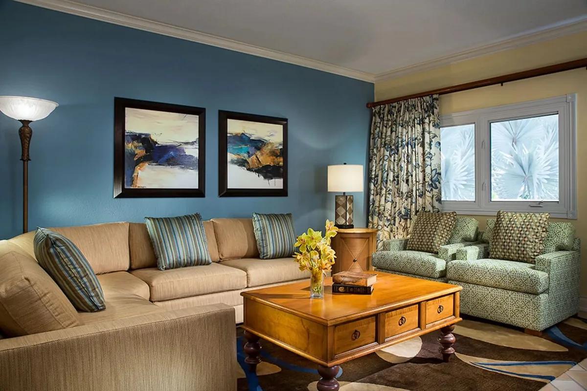 The living room of the one-bedroom residence, with sofa seating and a garden outlook