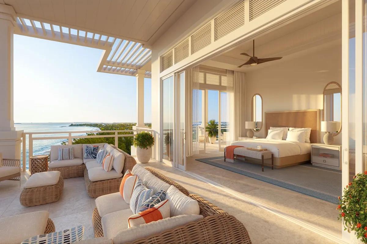 a bedroom opening onto a covered terrace above the sea