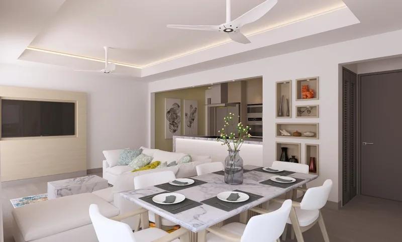 A white open-plan living and dining room with a ceiling fan and a table set for six