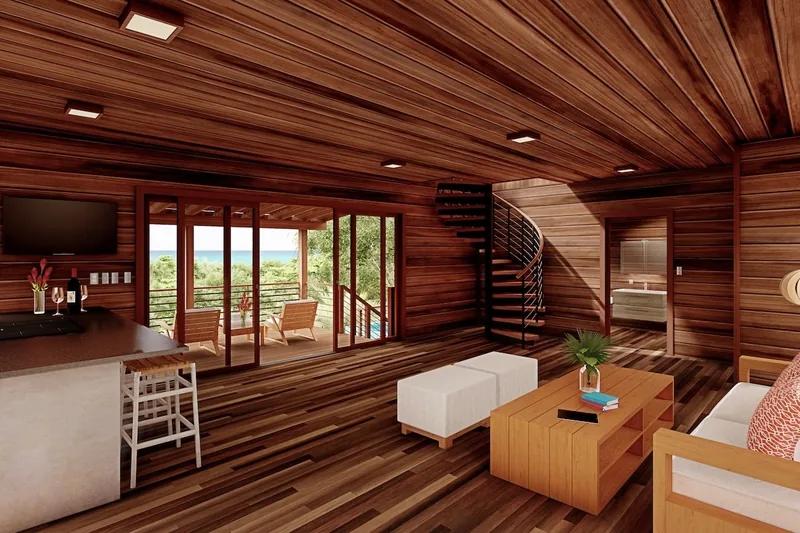 A timber-lined living room with a spiral stair and low sofas, doors open to the trees