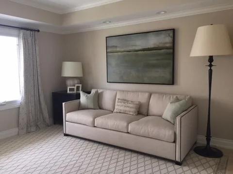 a sitting area with sofa and floor lamp