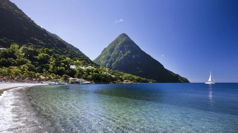 A Piton above a St Lucian bay, a yacht anchored in the calm water