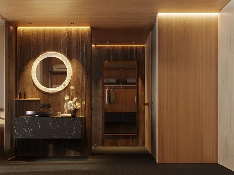 A timber-panelled dressing area with a round backlit mirror above a stone vanity