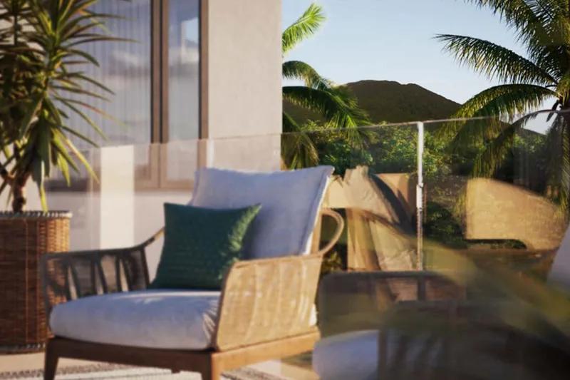 Artist’s rendering of a terrace with rattan armchairs and cushions, green hills beyond