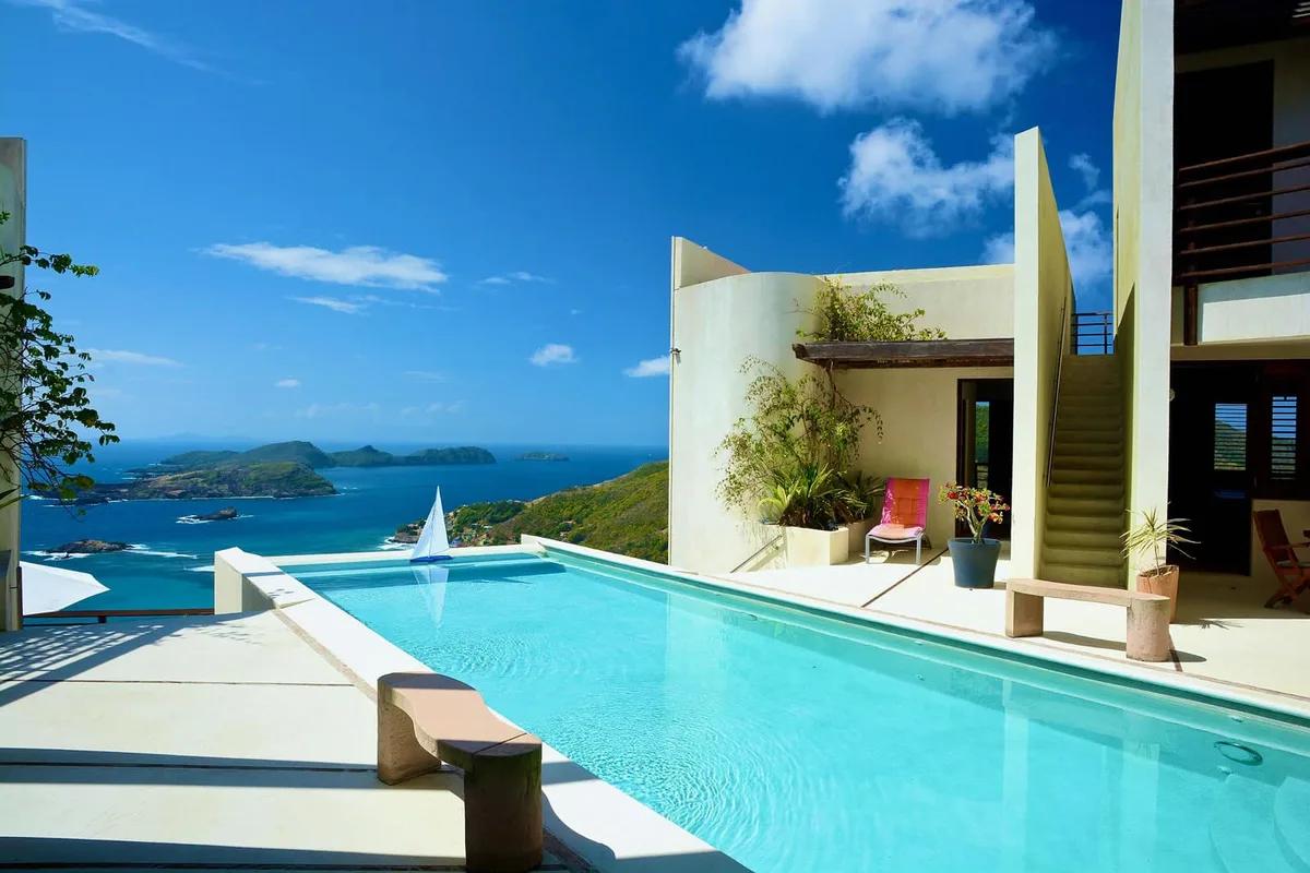 A curved-walled villa above a lap pool on Bequia, looking out over the sea to neighbouring islands