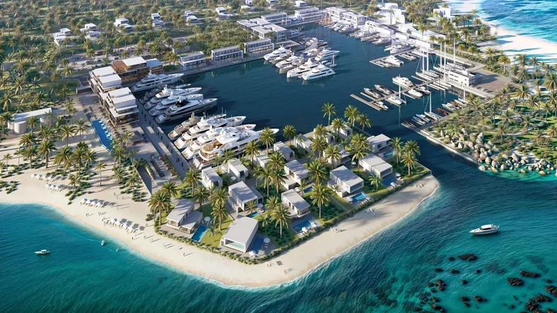 Artist’s rendering of a marina village built along a sandy spit, seen from the air