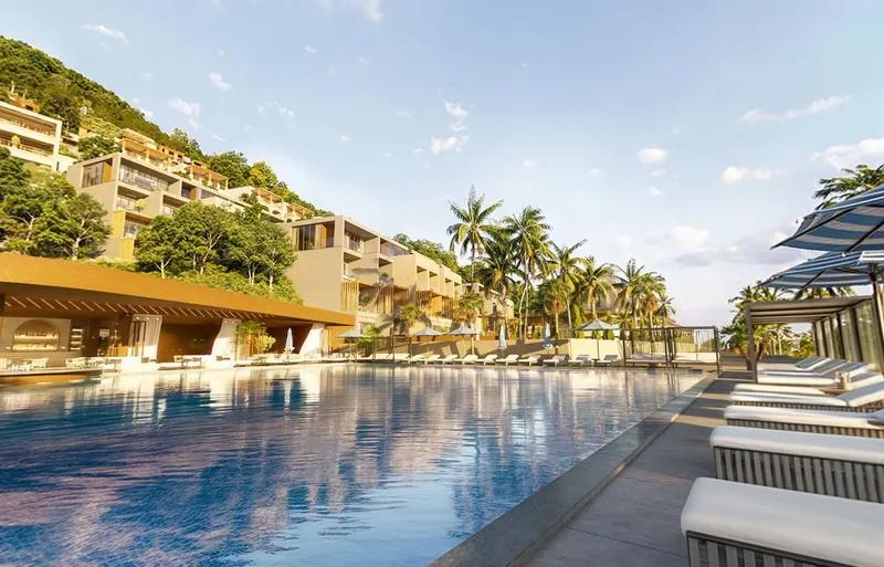 Artist’s rendering of a resort pool running between loungers and terraced apartment buildings