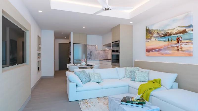 A pale living room with a blue sectional sofa and a beach scene painting on the wall