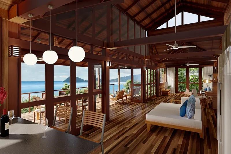 A timber pavilion under a vaulted roof, a day bed facing the open sea