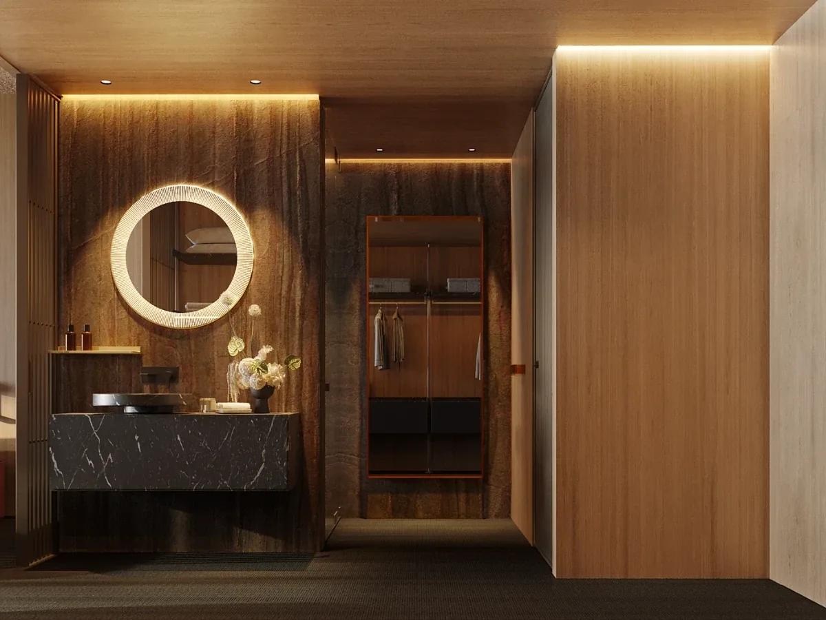 A timber-panelled dressing room with a round backlit mirror above a marble vanity