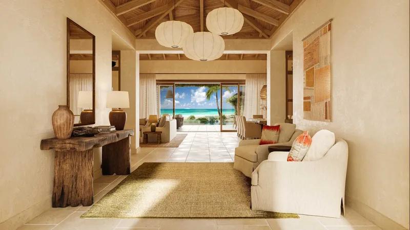 A room under a timber ceiling with woven pendant lanterns, looking through to the beach